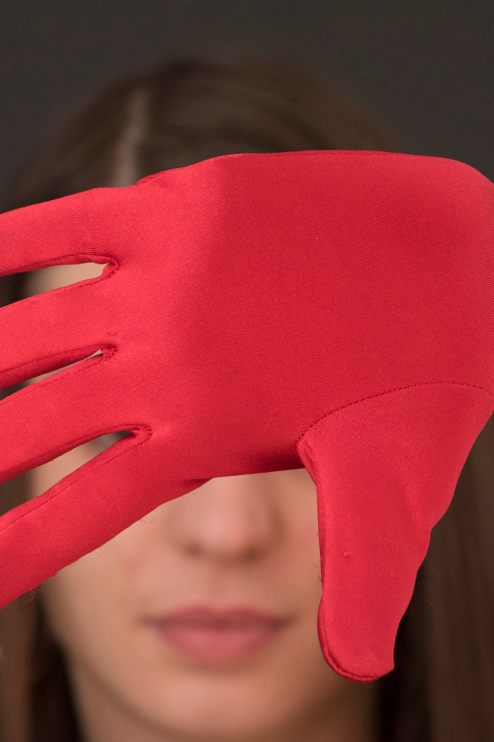 Girl showing confusion, hiding her face.